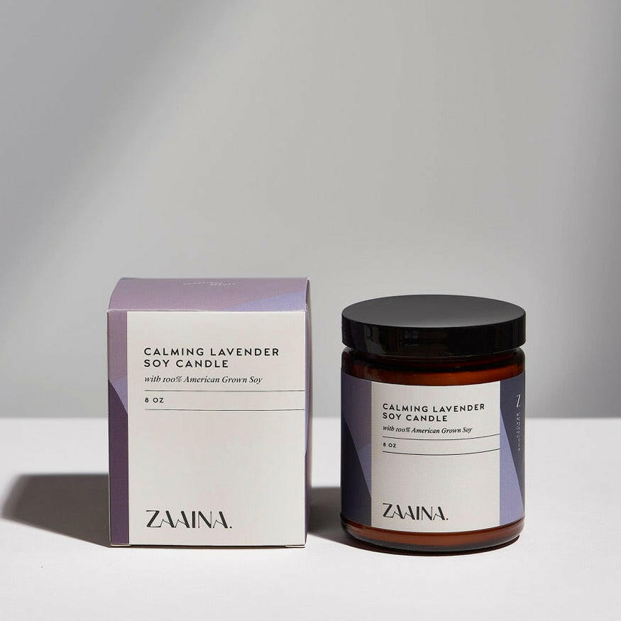 Elegant soy candle with lavender scent in glass jar, perfect for relaxation and soothing home ambiance.