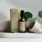 Lemongrass body oil in a glass bottle displayed on a wooden table for natural skincare routines