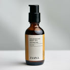 Ylang Ylang body oil bottle displayed with fresh flowers for natural skincare and aromatherapy benefits